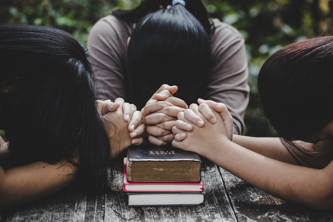 Group of Different Women Praying Together