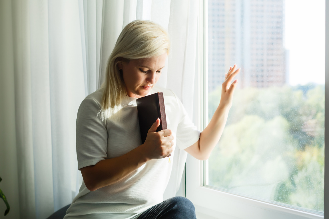 Religious faithful middle aged woman praying with hope faith hol