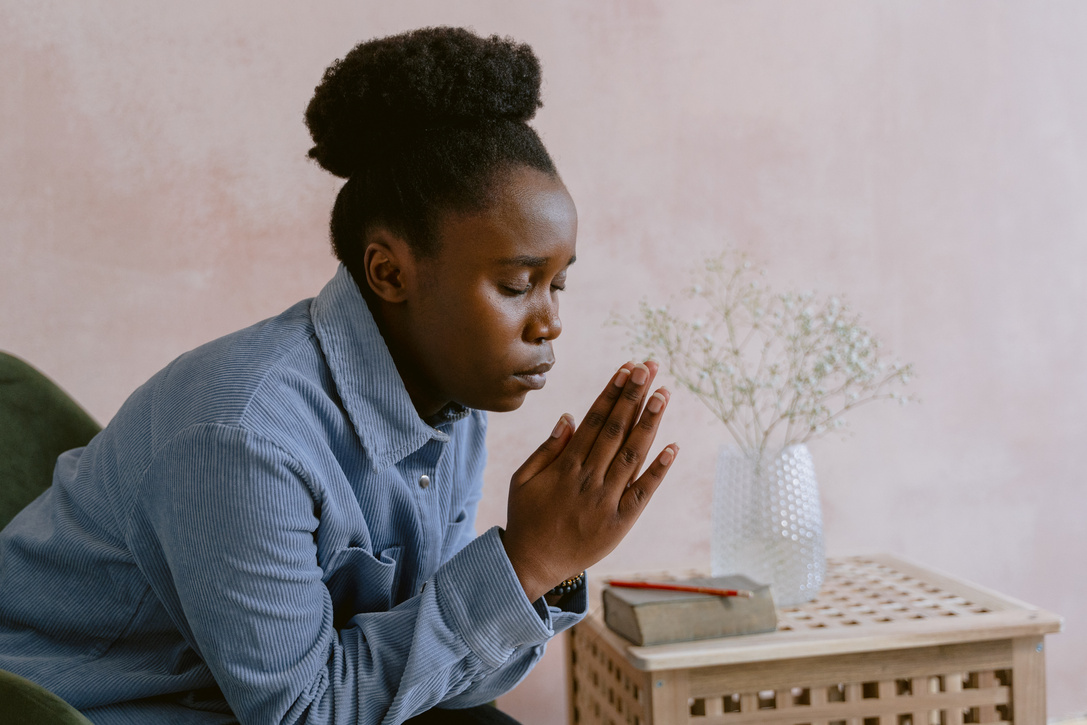 Young Woman Sitting and Praying