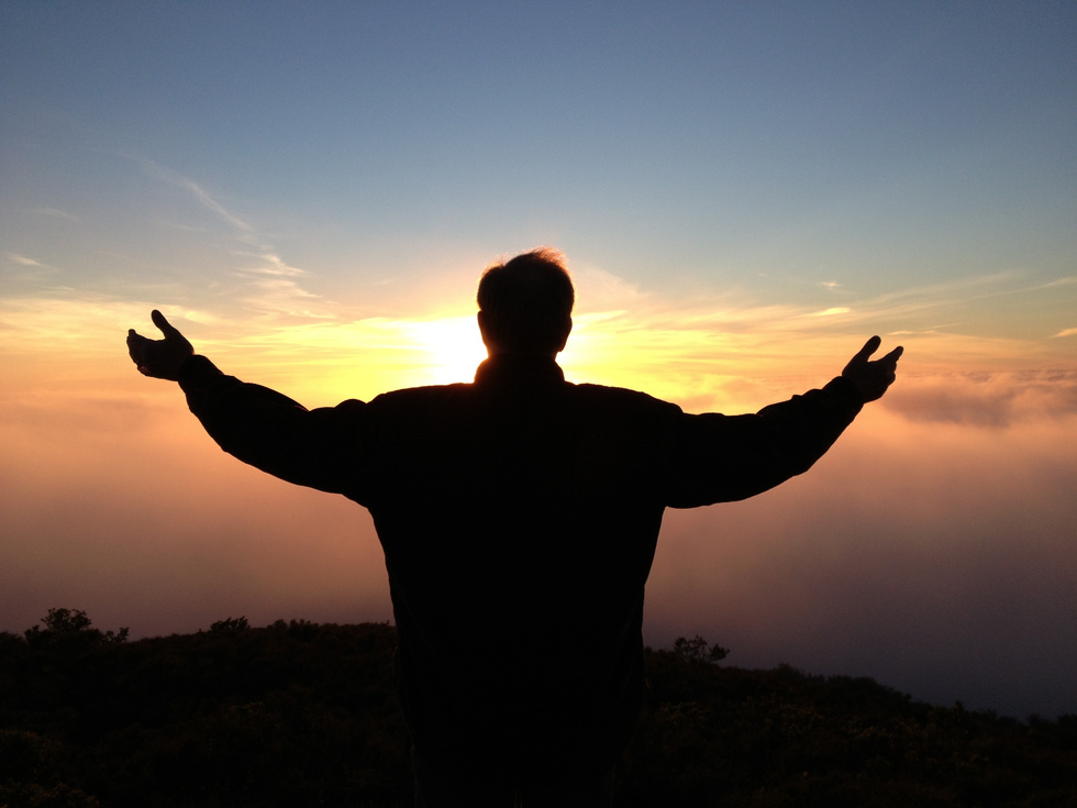 Silhouette of a Man Looking at the Clouds