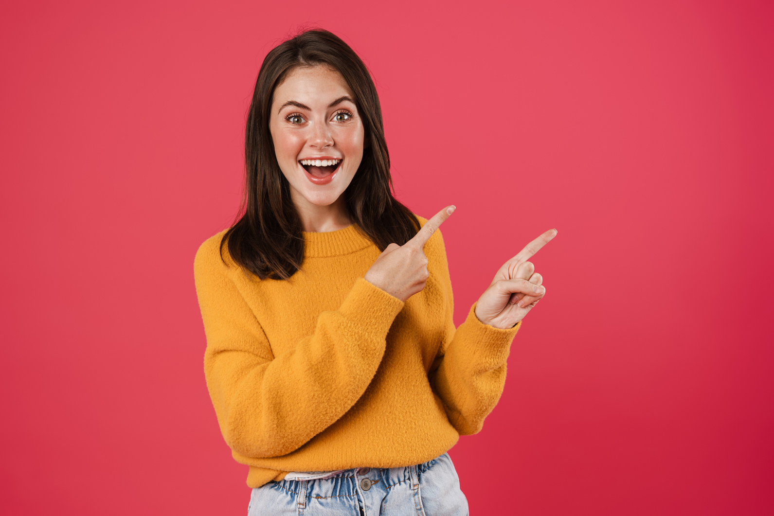 Image of Excited Beautiful Girl Pointing Fingers Aside