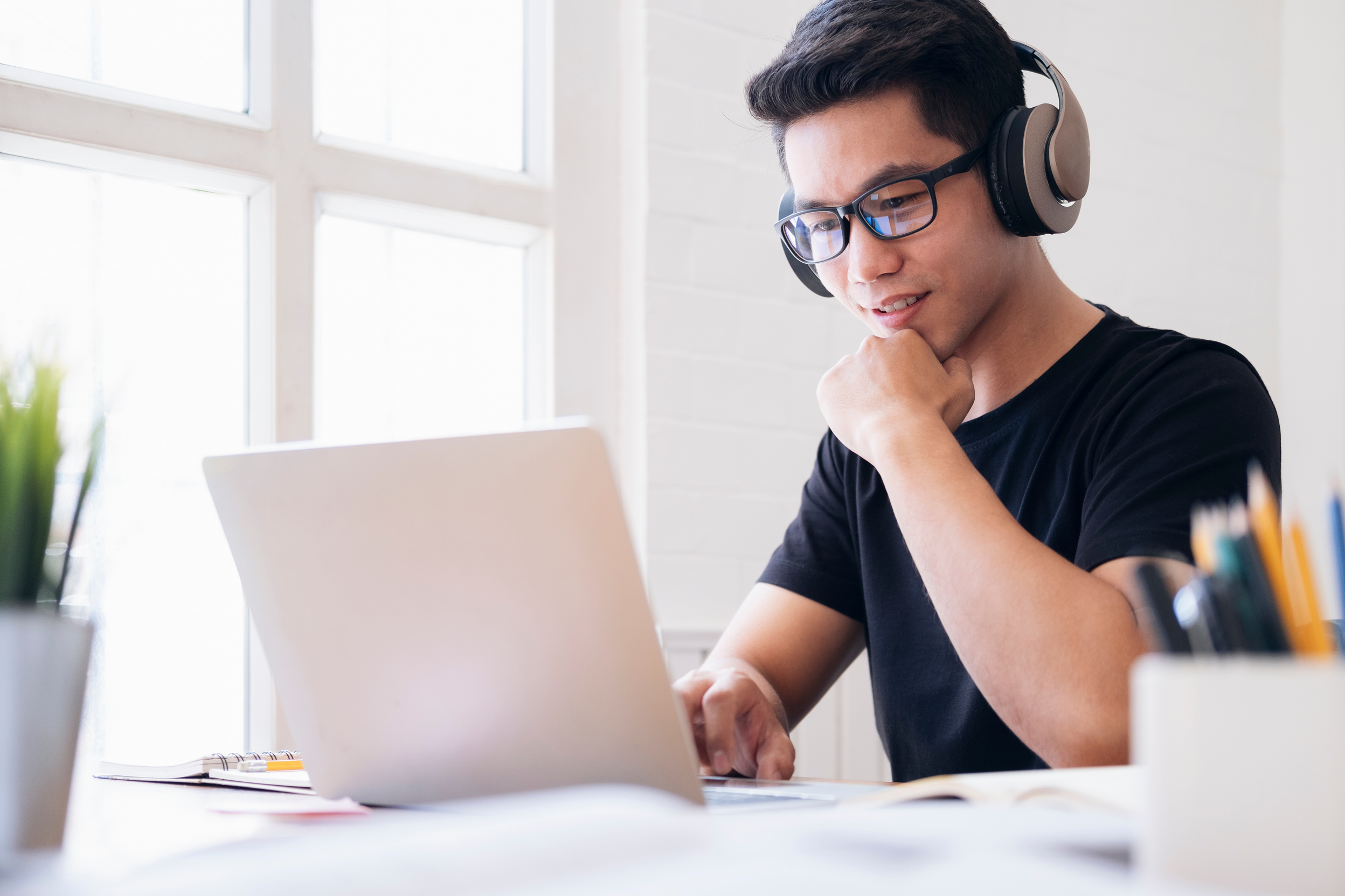 Young Man Using Computer in Studying